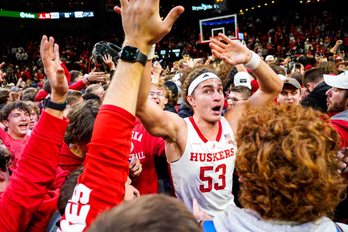 Nebraska forward Josiah Allick celebrates with fans who stormed the court after the Huskers' 88-72 win Tuesday night over top-ranked Purdue at Pinnacle Bank Arena in Lincoln. (Jan 9, 2024)